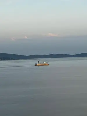 a boat in the middle of a large body of water at Studio climatisé belle vue mer in Ajaccio
