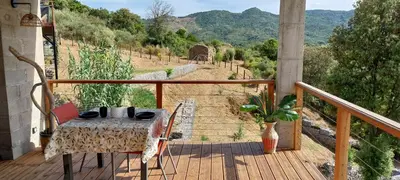 a table and chairs on a balcony with a view at Magnifique appartement entre mer et montagne in Tiuccia