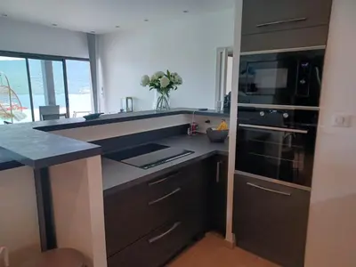 a kitchen with a sink and a stove top oven at Casa di l'Alivi - Villa avec vue exceptionnelle in Propriano