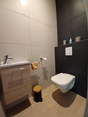 a bathroom with a white toilet and a sink at Casa di l'Alivi - Villa avec vue exceptionnelle in Propriano