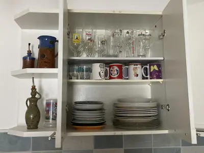 a cabinet filled with plates and cups and dishes at F3 hyper centre vieille ville coeur historique d'Ajaccio in Ajaccio