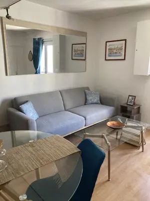 a living room with a couch and a glass table at F3 hyper centre vieille ville coeur historique d'Ajaccio in Ajaccio