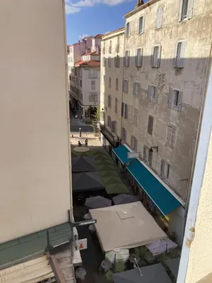 a view from a window of a building with umbrellas at F3 hyper centre vieille ville coeur historique d'Ajaccio in Ajaccio