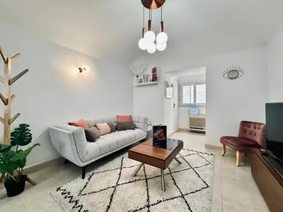 a living room with a couch and a coffee table at Magnifique deux pièces au cœur d Ajaccio in Ajaccio