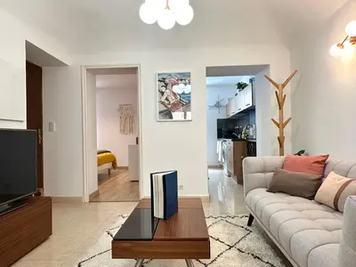 a living room with a couch and a tv at Magnifique deux pièces au cœur d Ajaccio in Ajaccio