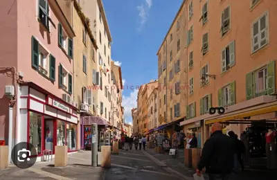 a street with buildings and people walking down a street at Magnifique deux pièces au cœur d Ajaccio in Ajaccio