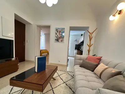 a living room with a couch and a tv at Magnifique deux pièces au cœur d Ajaccio in Ajaccio