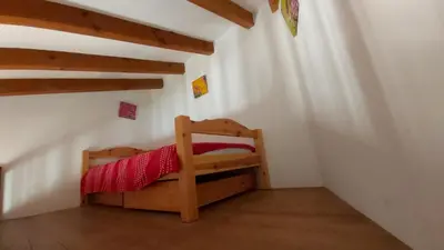 a bedroom with a bunk bed in a attic at Appartement Papillon avec Piscine et Vue Mer in Propriano