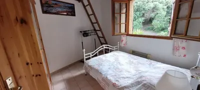 a small bedroom with a bed and a window at Appartement Papillon avec Piscine et Vue Mer in Propriano