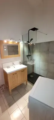 a bathroom with a sink and a shower at Appartement Papillon avec Piscine et Vue Mer in Propriano