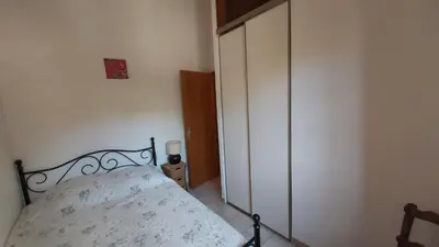 a bedroom with a bed and a closet at Appartement Papillon avec Piscine et Vue Mer in Propriano