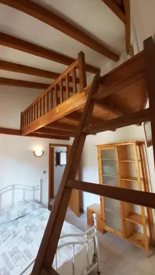 a loft bed in a bedroom with a bunk bed at Appartement Papillon avec Piscine et Vue Mer in Propriano