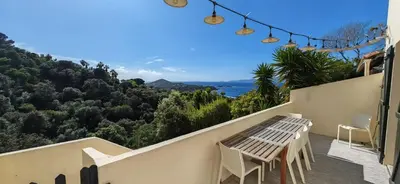 a balcony of a house with a table and chairs at Villa familiale superbe vue mer et couchers de soleil in Pietrosella