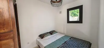 a bedroom with a bed and a window at Villa familiale superbe vue mer et couchers de soleil in Pietrosella