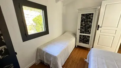 a small room with two beds and a window at Villa familiale superbe vue mer et couchers de soleil in Pietrosella