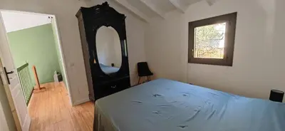 a bedroom with a bed and a large mirror at Villa familiale superbe vue mer et couchers de soleil in Pietrosella
