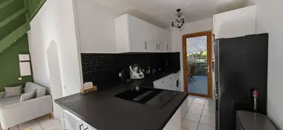 a kitchen with a black counter top in a room at Villa familiale superbe vue mer et couchers de soleil in Pietrosella