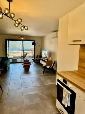 a living room with a view of the ocean at Appartement confort vue mer in Propriano