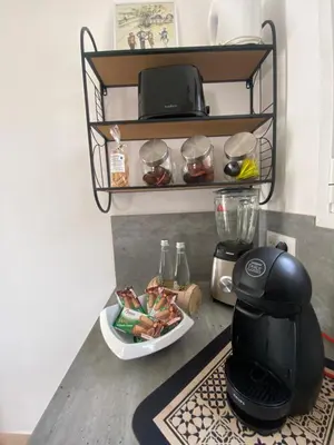 a coffee maker and a plate of food on a counter at Casa Sole e Mare in Borgo