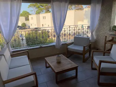 a balcony with two chairs and a table and a window at Casa Sole e Mare in Borgo