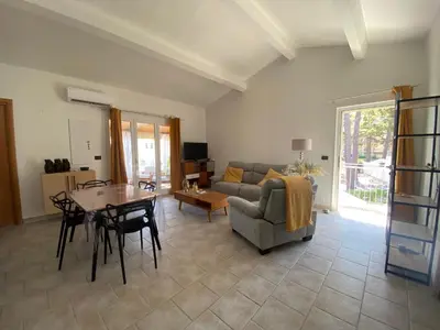 a living room with a table and a couch at Casa Sole e Mare in Borgo