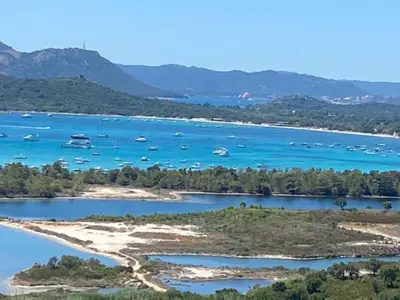 an island in a body of water with boats at Villa EDEN BLUE in Zonza