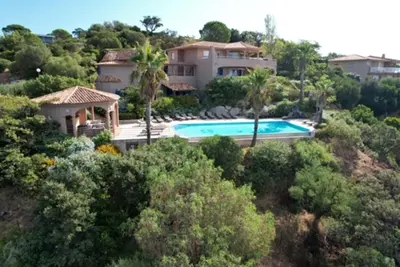 a house on a hill with a swimming pool at Villa EDEN BLUE in Zonza