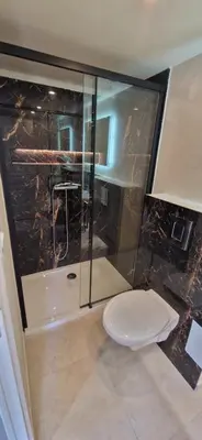 a bathroom with a glass shower with a toilet at Studio folelli entre le centre et la plage in Penta-di-Casinca