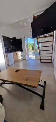 a wooden table in a room with a kitchen at Studio folelli entre le centre et la plage in Penta-di-Casinca
