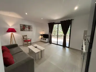 a living room with a couch and a table at Casa Mya in Porto-Vecchio