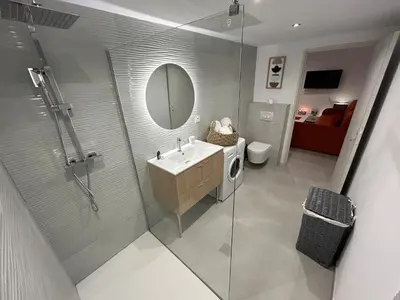 a bathroom with a shower and a sink and a mirror at Casa Mya in Porto-Vecchio