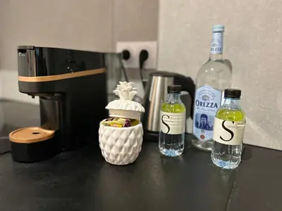 a counter with two bottles of wine and a coffee maker at Casa Mya in Porto-Vecchio