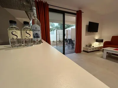 a kitchen with two bottles of alcohol on a counter at Casa Mya in Porto-Vecchio
