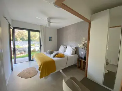 a bedroom with a bed and a large window at Casa Felicia in Bonifacio
