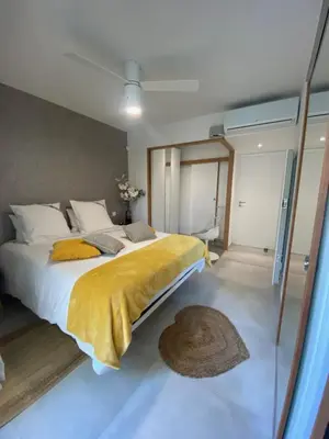 a bedroom with a large bed with a yellow blanket at Casa Felicia in Bonifacio