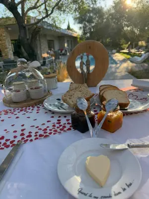 a table topped with plates of food and spoons at Casa Felicia in Bonifacio
