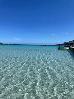 a large body of water with a boat in it at Casa Sophie in Capo