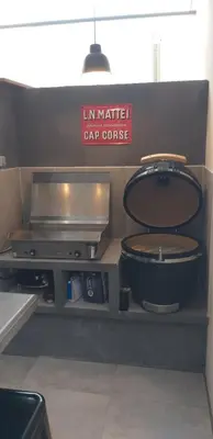 a kitchen with a counter with a stove and a sign at Casa Sophie in Capo