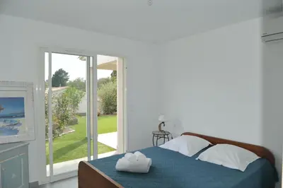 a bedroom with a bed with two towels on it at CASA VIGNA - villa T4 piscine privée in Sainte-Lucie de Porto-Vecchio