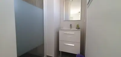 a bathroom with a sink and a mirror at CASA VIGNA - villa T4 piscine privée in Sainte-Lucie de Porto-Vecchio