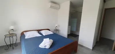 a bedroom with a bed with towels on it at CASA VIGNA - villa T4 piscine privée in Sainte-Lucie de Porto-Vecchio
