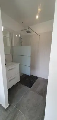 a bathroom with a shower and a sink and a mirror at CASA VIGNA - villa T4 piscine privée in Sainte-Lucie de Porto-Vecchio