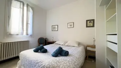 a bedroom with a bed with blue pillows on it at Casamea - Spacieux, Famille, Hyper-centre in Ajaccio