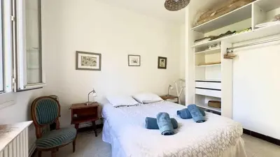 a bedroom with a bed with blue pillows on it at Casamea - Spacieux, Famille, Hyper-centre in Ajaccio
