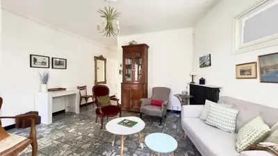 a living room with a couch and a table at Casamea - Spacieux, Famille, Hyper-centre in Ajaccio