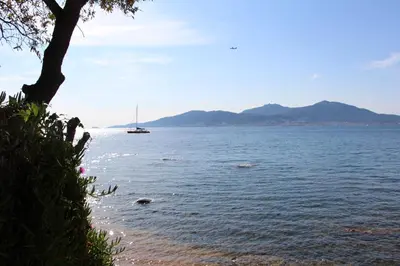 a sail boat in a large body of water at Duplex à 100 m de la plage in Grosseto-Prugna