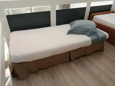 a large bed in a room with at Duplex à 100 m de la plage in Grosseto-Prugna