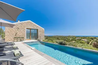 a swimming pool in a villa with a view at Villa A Grana in Zonza