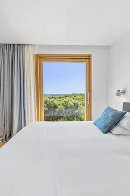 a bedroom with a large bed and a window at Villa A Grana in Zonza