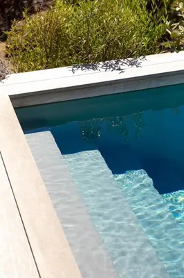 a swimming pool with blue and white water at Villa A Grana in Zonza
